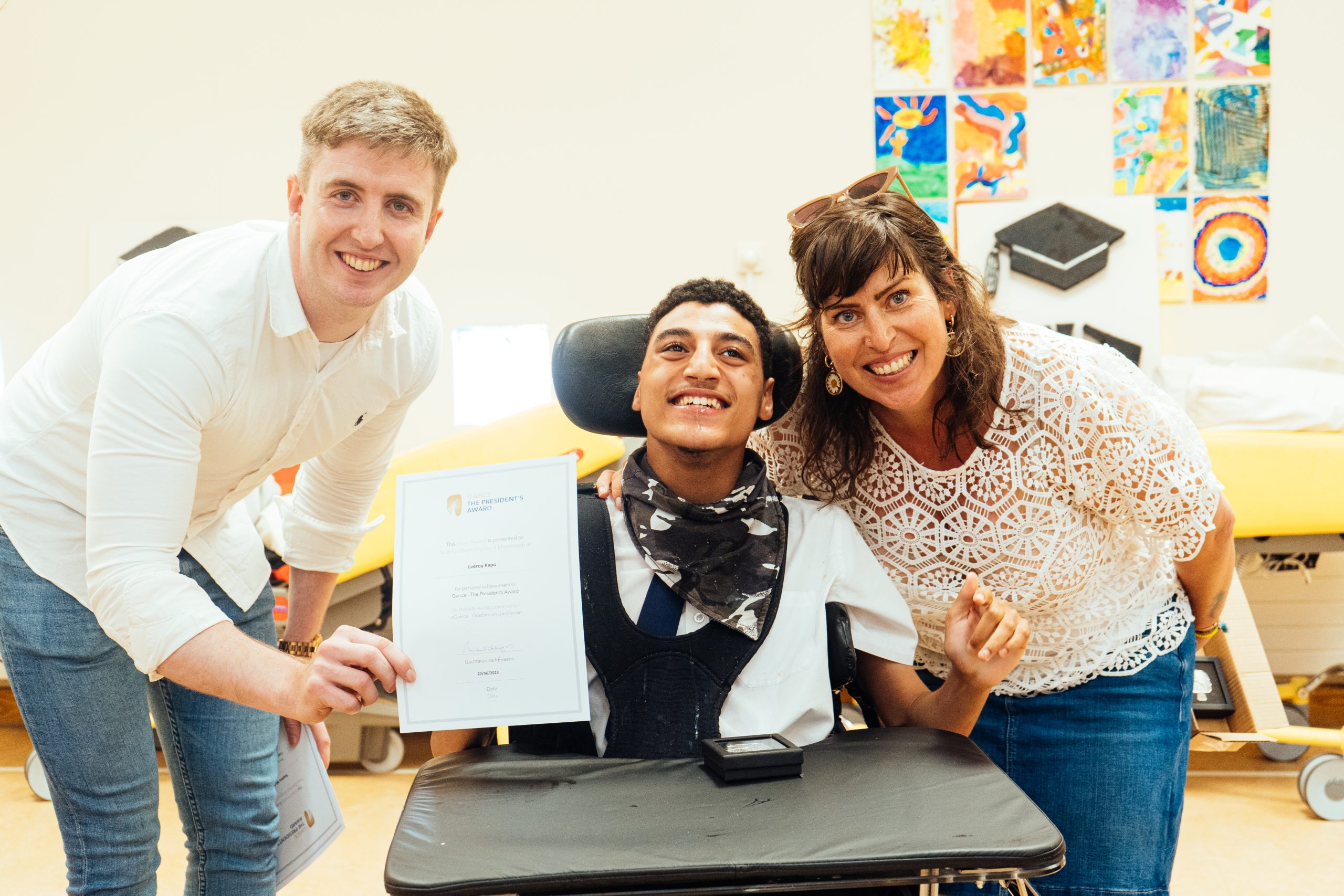teenagers, one in a wheelchair, two standing
